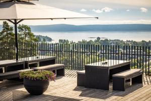 阿斯克尔梁科林品质酒店 的一个带长椅和遮阳伞的庭院,享有水景