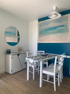 塔勒蒙Vue mer, superbe appartement refait à neuf!的一间配备有白色桌椅的用餐室