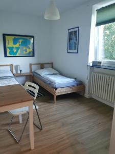 KronshagenGemütliche Gästewohnung in ruhiger Lage的客房设有一张床、一张桌子和一张桌子。
