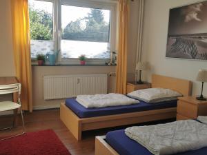 KronshagenGemütliche Gästewohnung in ruhiger Lage的带窗户的客房内的两张床