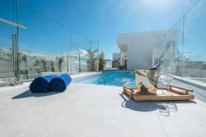 塞维利亚Sercotel Sevilla Guadalquivir Suites的一座带游泳池和一瓶葡萄酒的房子
