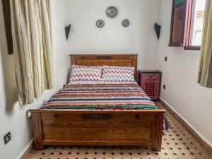 丹吉尔丹吉尔卡斯巴旅舍的一间卧室,卧室内配有一张木床