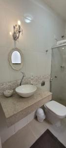 科伦巴Sobrado 2 amplo e confortável em condomínio的一间带水槽、卫生间和镜子的浴室