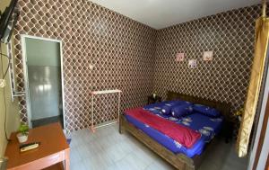 MendutPondok kali oedal的一间卧室配有蓝色的床和镜子