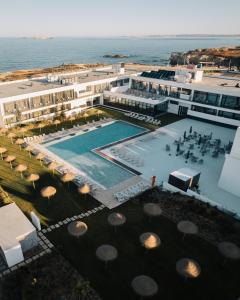 科武港Porto Covo Praia Hotel & SPA的享有带游泳池的度假村的空中景致