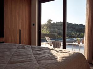阿利卡纳斯Drallos Luxury Villa的一间卧室设有一张床和一个大窗户