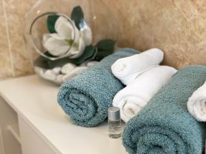布雷谢洛B&B STAZIONE DON CAMILLO的浴室的台面上摆放着一堆毛巾