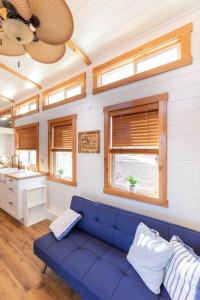 Apple ValleyAloha Tiny Home的客厅设有蓝色的沙发和窗户。