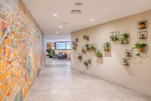 巴塞罗那巴塞罗那馨乐庭兰布拉酒店的墙上挂有植物的走廊