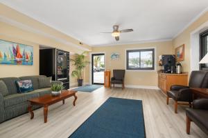 大洋城海岸棕榈树客栈及套房酒店的客厅配有沙发和桌子