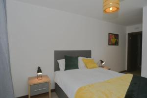 滨海绍森德Amazing Central Southend,2-bedroom flat,10th floor的一间卧室配有一张床和两张带台灯的桌子。