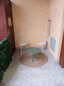 布尔昆Le Temps d'une Pause的庭院里设有两把椅子和一张桌子