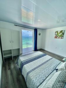 巴尔Villas Encanto的一间卧室设有一张床和一个海景窗户