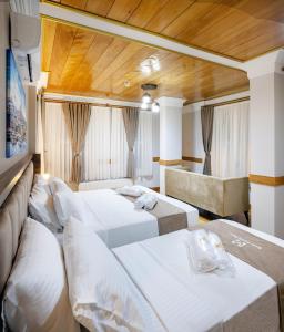 伊斯坦布尔HOME QUALITY HOTEL的酒店客房,设有三张床和一张沙发