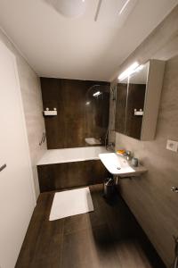 哈拉霍夫90 m2 horský apartmán v centru Harrachova的浴室配有盥洗盆和浴缸。