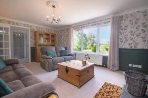 因弗内斯Calm Scottish Country Escape with Hot Tub Sleeps 6的客厅配有沙发和桌子