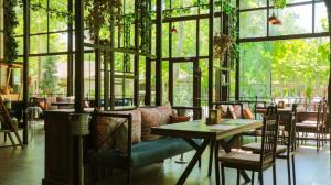 纳布兰VOGUE HOTEL RESORT AND SPA - Nabran的餐厅设有桌椅和窗户。