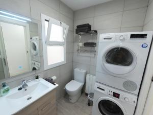 塔拉戈纳Apartamento New Tarraco的浴室位于卫生间旁,配有洗衣机。