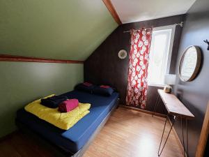 圣安娜德蒙Chill Shack - Auberge Jeunesse的一间设有蓝色床的卧室,位于一个设有窗户的房间