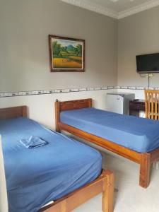 库塔捷鹏塞加拉旅馆的一间卧室配有两张床和电视。