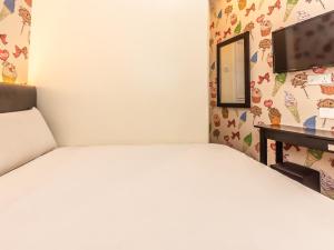 马六甲Gold City Hotel的一间卧室配有一张床、一张书桌和一面镜子