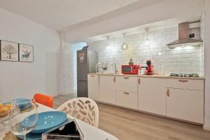 阿利坎特Apartament Mercado Central的一间厨房,内设白色橱柜和一张桌子