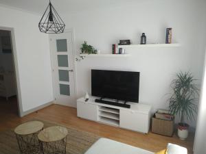拉科鲁尼亚El Apartamento de Marta的客厅配有白色橱柜上的平面电视