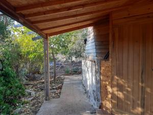 Manotבקתת עץ בחורש במנות - דום גיאודזי - Wooden cabin in Manot的木结构建筑,设有木屋顶