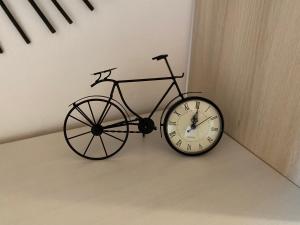 梅塔比耶Au-Doux-Altic chalet romantique avec JACUZZI ET SAUNA的自行车旁的墙上挂着一个钟