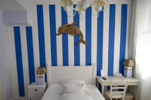 杜塞尔多夫哈姆酒店的一间卧室配有一张床和蓝白色条纹墙