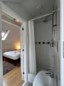 卢顿里塞酒店的一间带水槽和淋浴的浴室以及一张床
