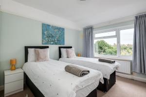 牛津Cheerfull 3-Bedroom Home with parking & garden的带窗户的客房内的两张床