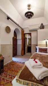 马拉喀什RIAD DAR En-Nawat的一间卧室配有一张带白色毛巾的床