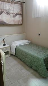 布林迪西曼佐尼住宿加早餐旅馆的一间卧室配有一张床和一张带台灯的桌子