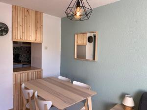 拉姆吉Plein centre station vue imprenable的一间带木桌和椅子的用餐室