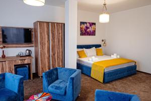 布勒伊拉RaAy的一间卧室配有一张床和两张蓝色椅子