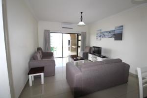 乌旺戈海滩Saints View Resort Unit 13的客厅配有两张沙发和一台电视机