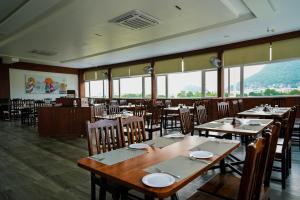 维杰亚瓦达HOTEL SUNRISE HOSPITALITY的用餐室设有桌椅和窗户。