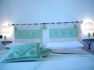 阿尔盖罗Le Pavoncelle的一间卧室配有两张床和蓝色的灯光