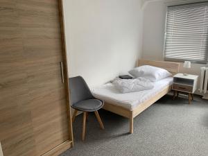 ZielitzWohnung 85 qm Kalimandscharo 1 in Zielitz - Magdeburg的卧室配有一张床和一把椅子,位于门边