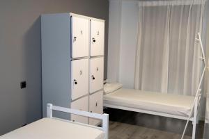苏维里Suseia的一间卧室配有两张床和白色橱柜