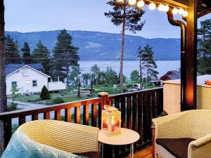 赫讷福斯Holiday home Hønefoss的阳台配有桌椅,享有水景。