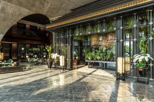 曼谷曼谷新通凯宾斯基酒店的种植盆栽植物的建筑的大厅
