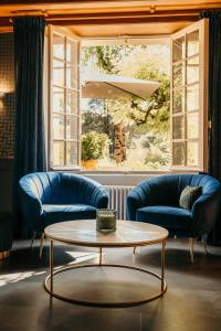 莱塞齐耶德泰阿克克罗马努酒店的客厅配有2张蓝色的沙发和1张桌子