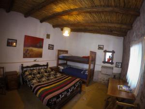 蒂尔卡拉Casamolle Hostel的一间卧室设有两张床和木制天花板