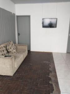 阿雷格里港Hostel Cachoeira的带沙发和平面电视的客厅