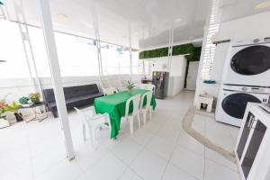 卡塔赫纳Hostal Casa Dandy的客厅配有绿桌和洗衣机