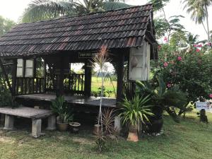 巴佐Seri Pengkalan Homestay的花园中带长凳的小房子