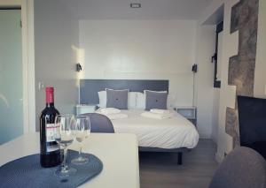 圣尼科拉斯村De Sebastian 1 - estudio frente al mar的配有一张带酒杯桌子的床的房间