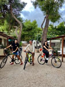 纳夫普利翁XeniCamp-Retreat的一群人骑着自行车停在树旁